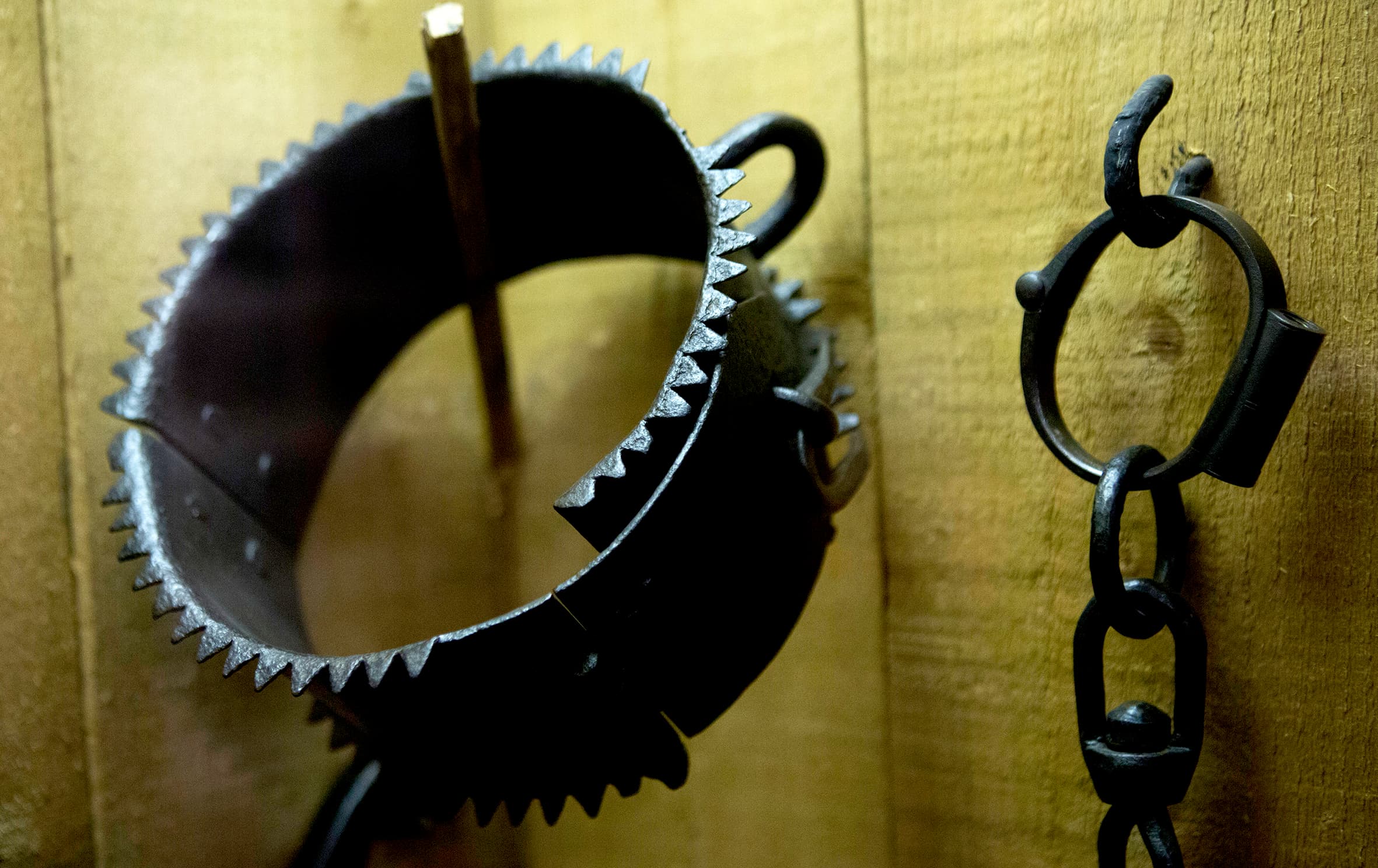 A black metal ring with a chain attached, showcasing a sturdy design suitable for various applications.