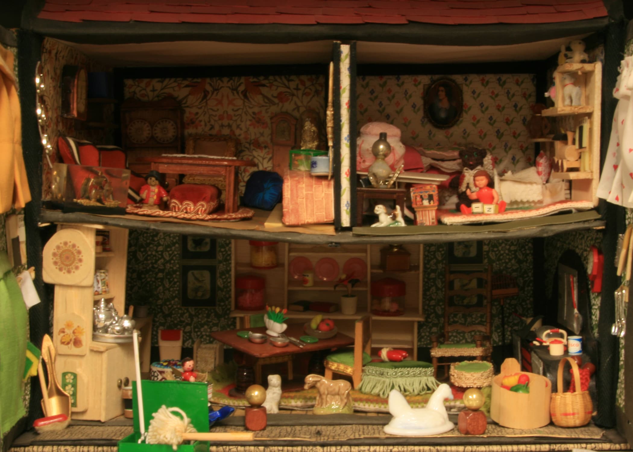 A colorful dollhouse featuring a doll positioned inside, showcasing its intricate design and playful details.