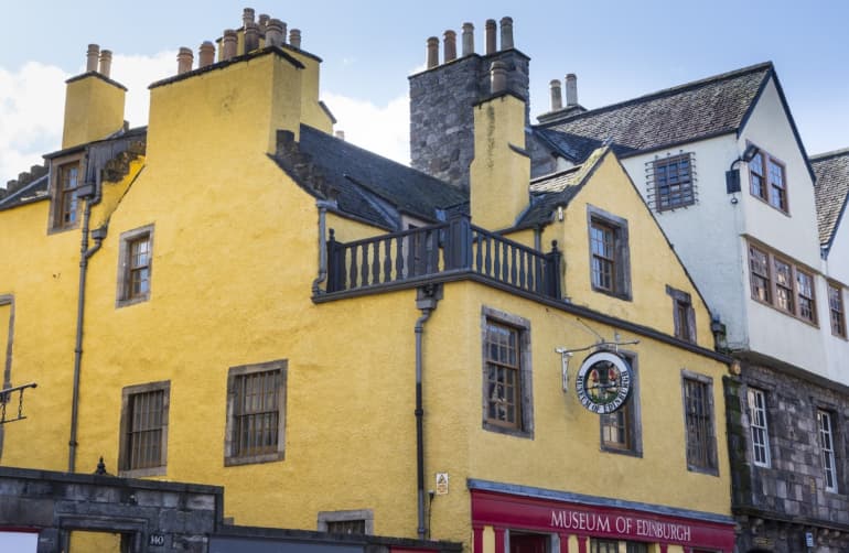 The Museum of Edinburgh, a bright yellow building dating back to the 16th century, on the historic Royal Mile.