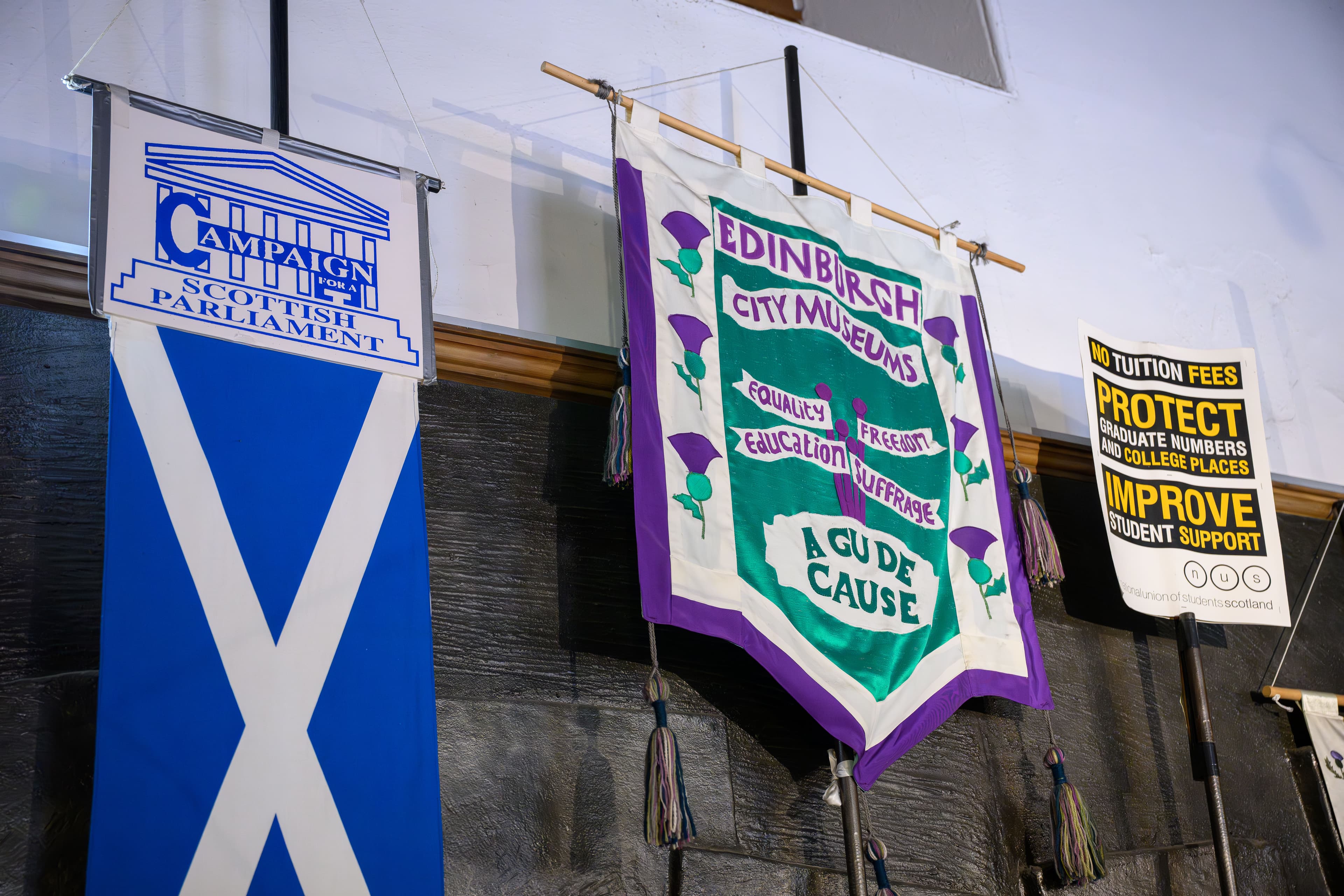A series of banners arranged on a wall, each displaying unique graphics and text.