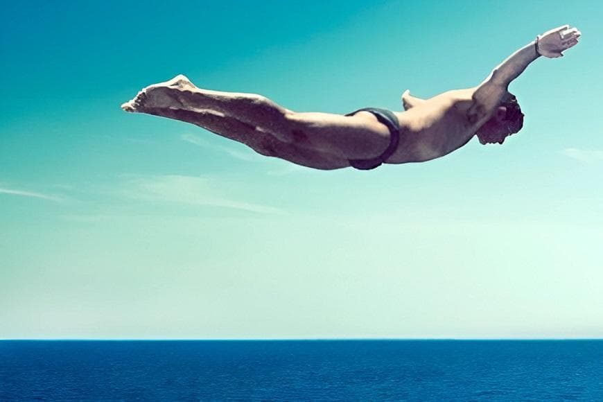 Photograph of Oliver Burkeman diving in to the sea