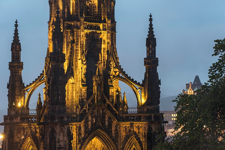 A towering monument structure with distinctive stonework, showcasing architectural elegance against the skyline.