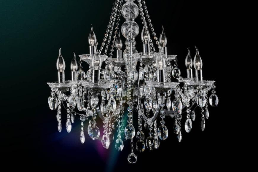 Black and white photo of a chandelier with a jewel colour wash