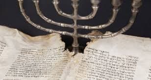 Photo of aged Jewish text and Menorah